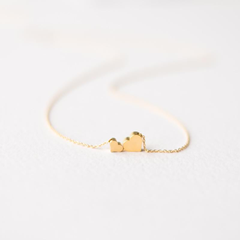 Delicate two gold hearts necklace